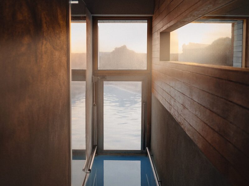 a room with a glass floor and a view of the water